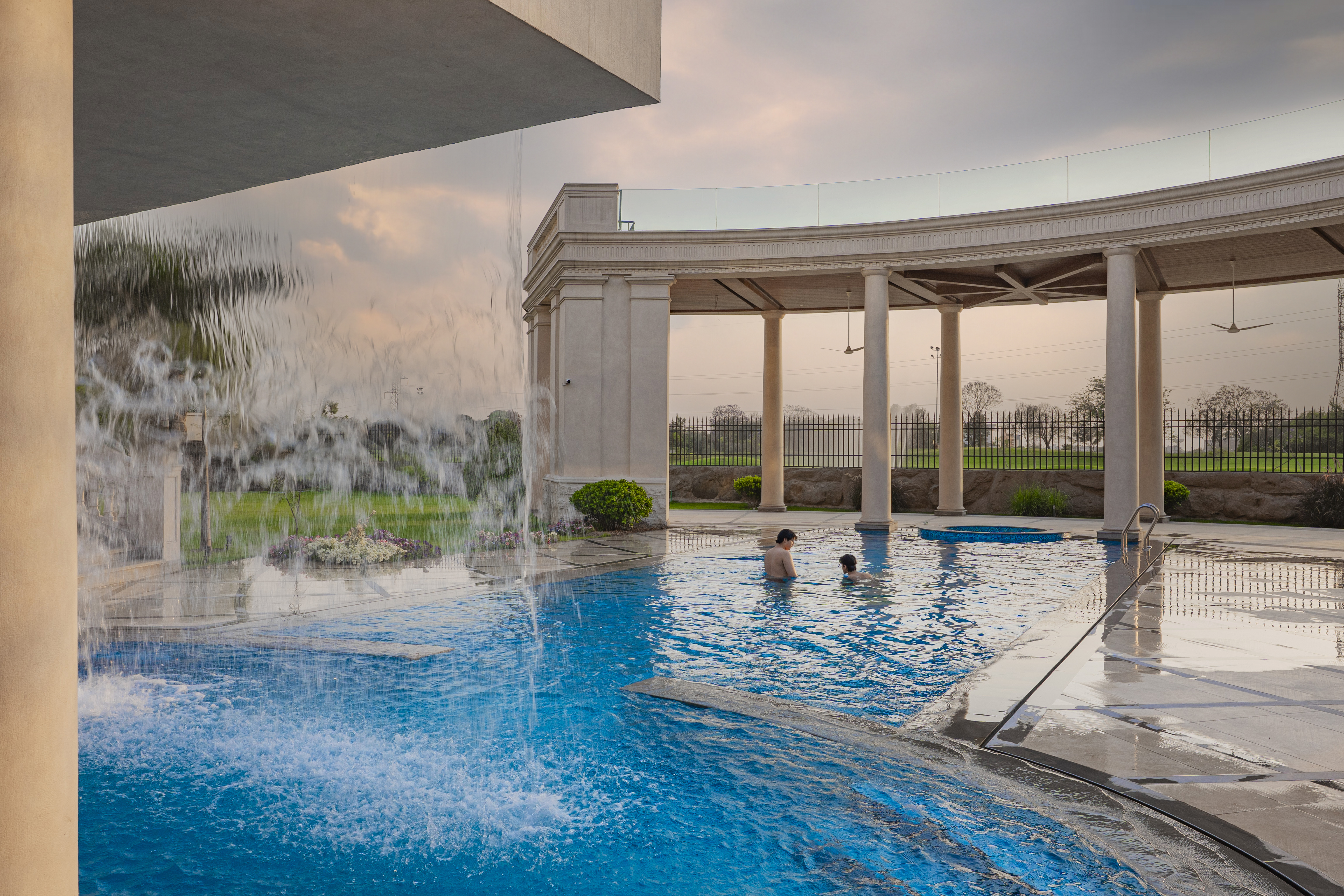 Golden hour estate pool showing architectural design context